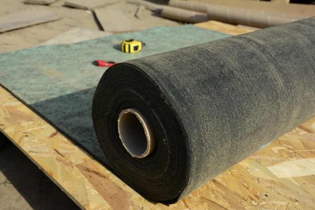 gathering proper materials and tools for roof replacement like roof underlayment