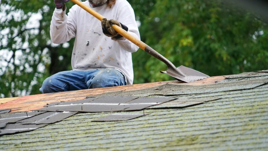 contractor shows how to remove roof shingles