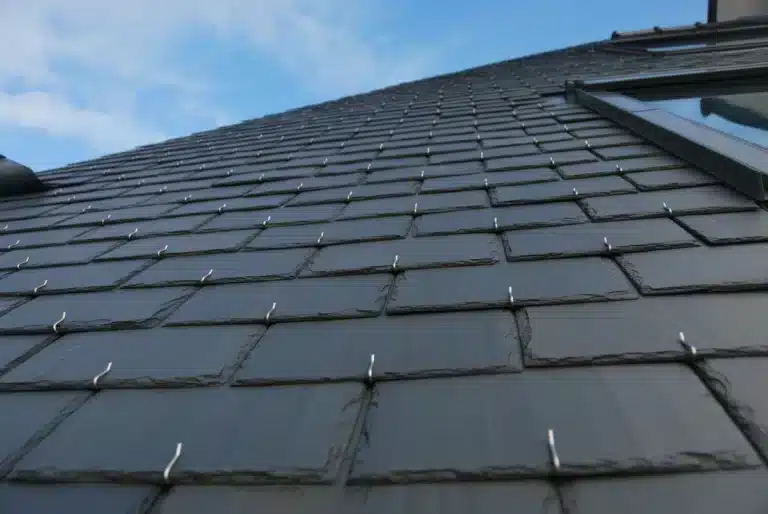Close up view of composite roof shingles in synthetic slate roofing style