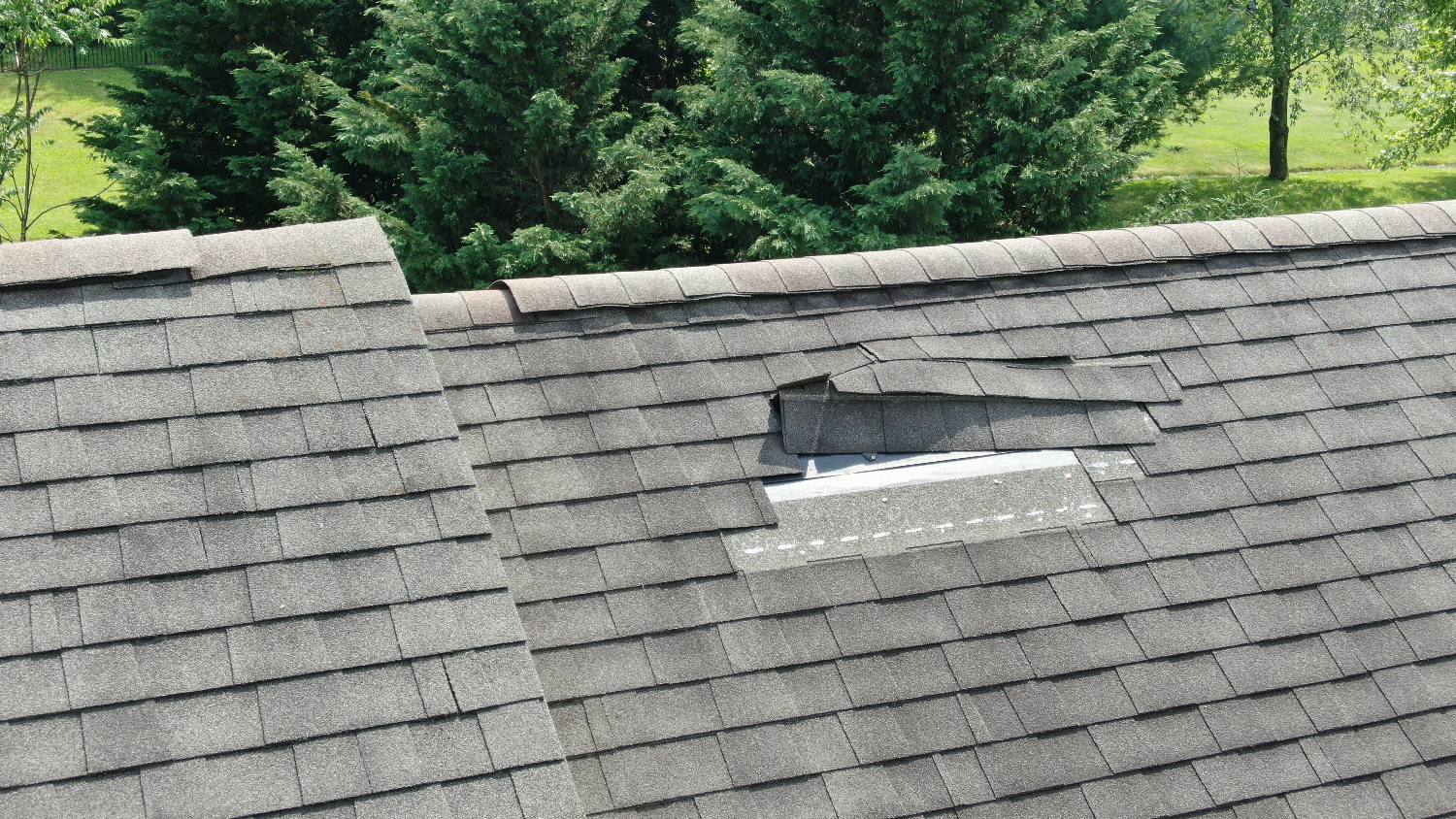 Roof with missing shingles, requiring replacement